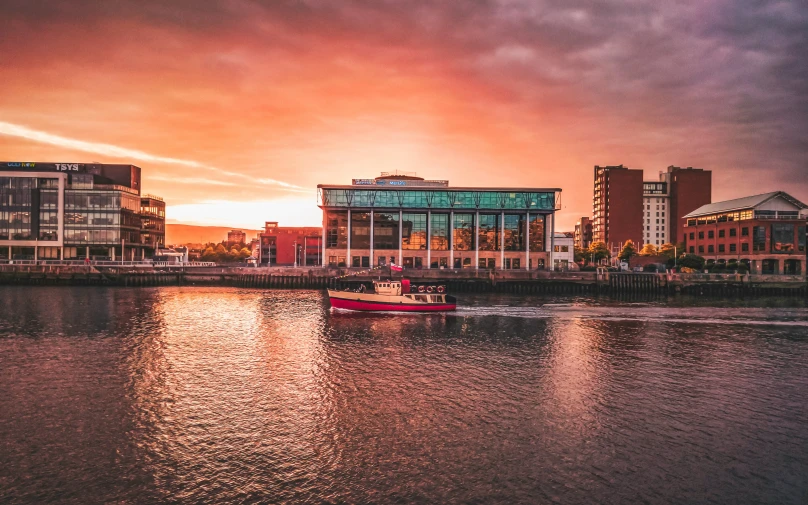 a boat that is out on the water near buildings