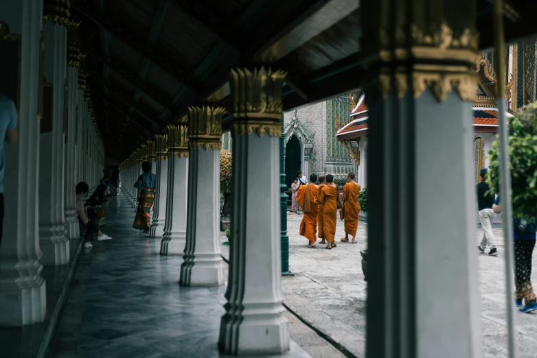 two monks walking on a path next to a building