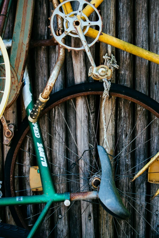 old bicycle frame from the past with other vintage bicycles hanging up