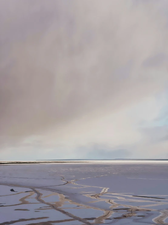 a person is walking along some snow - covered ground