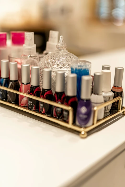 a gold tray holds nail polish and other makeup products