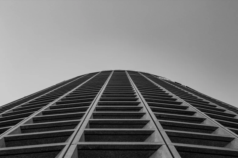 an upward view of the top of a building in black and white