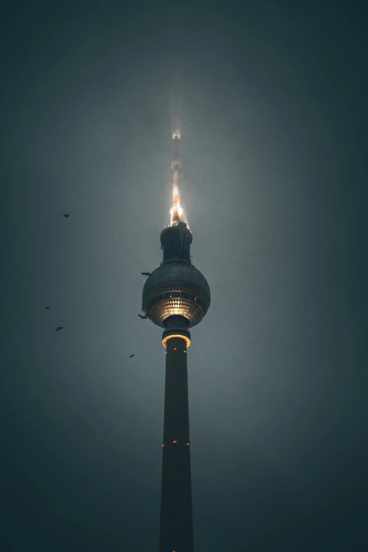 the top of a very tall pole on a dark background