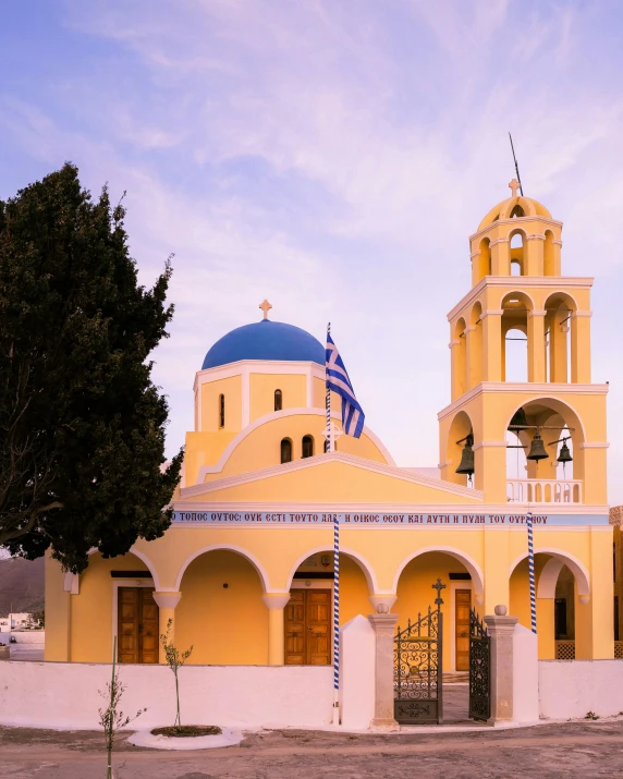 a large yellow church with two bell towers