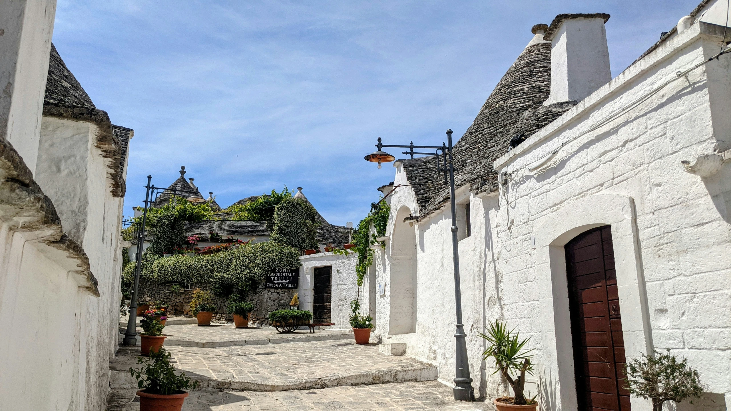 a street view from the end with white buildings