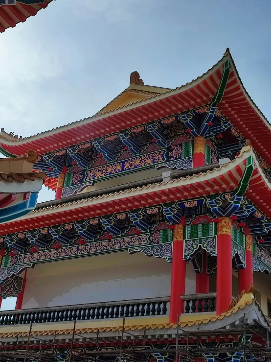 many large colorful asian buildings with red trim