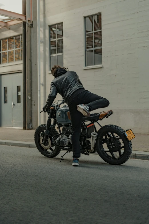 a man sitting on a motorcycle near the street