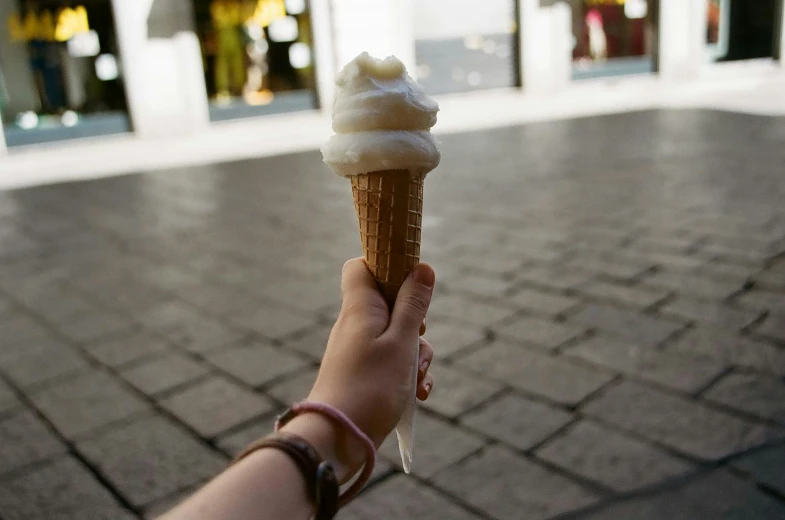 a person holding a giant cone with a cone inside