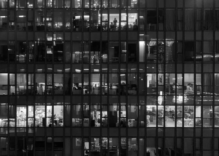 a very tall building with some windows and lights on