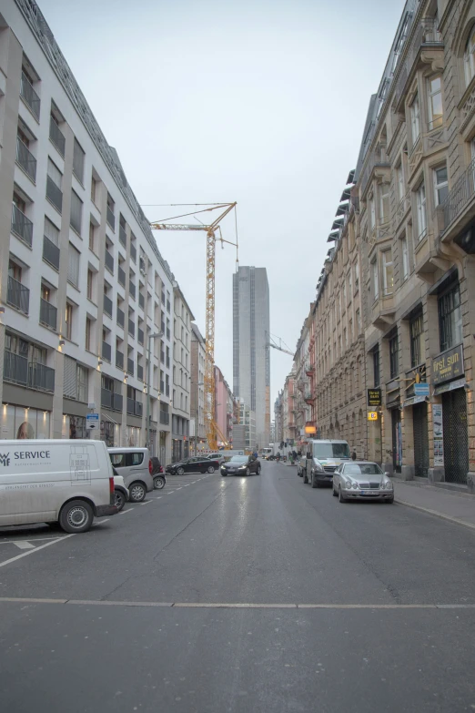 a city street that has buildings on both sides and cars on it