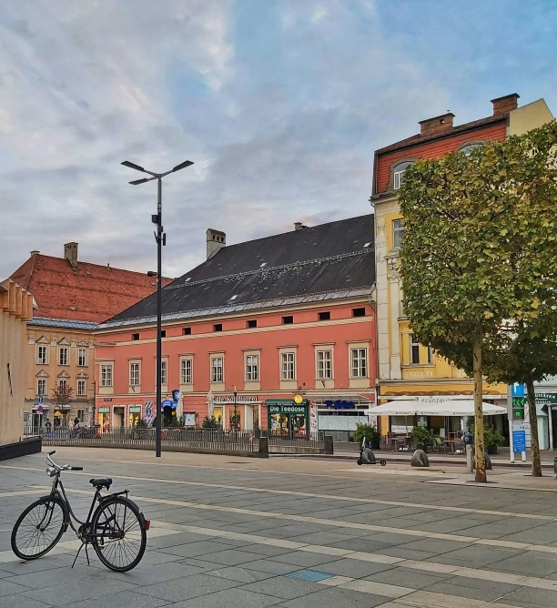 two bicycles parked next to a building in the middle of town