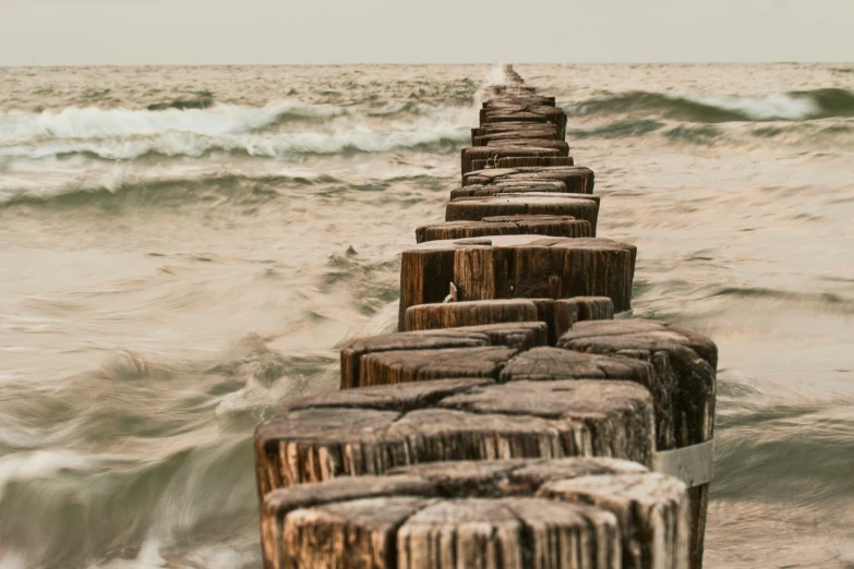 a pier in front of some water with waves