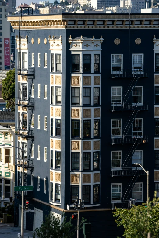 a tall gray apartment building with many windows