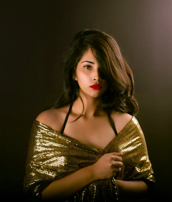 a woman posing in a gold dress