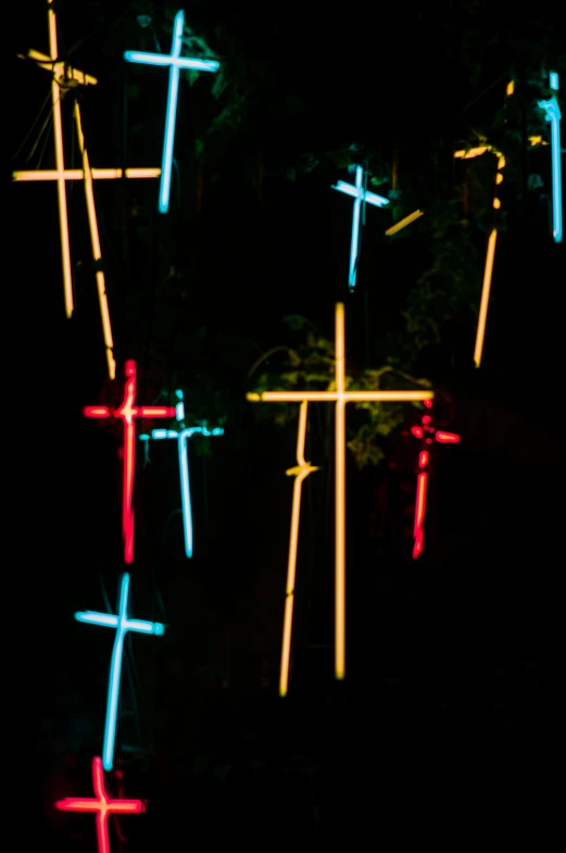 a wall with bright colored crosses mounted on it