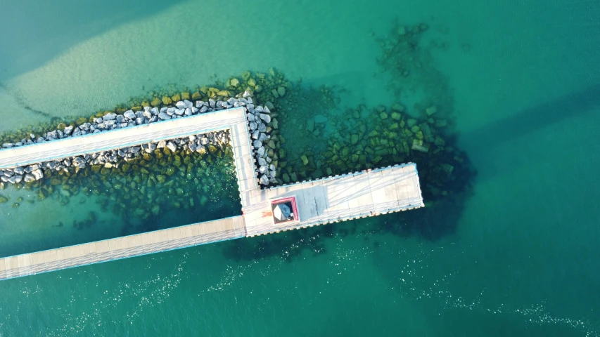 a concrete pier extending into water on an island