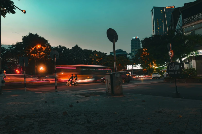 a person is riding a bike at night near an intersection