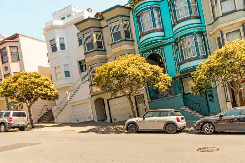 several cars parked on the street in front of multiple buildings