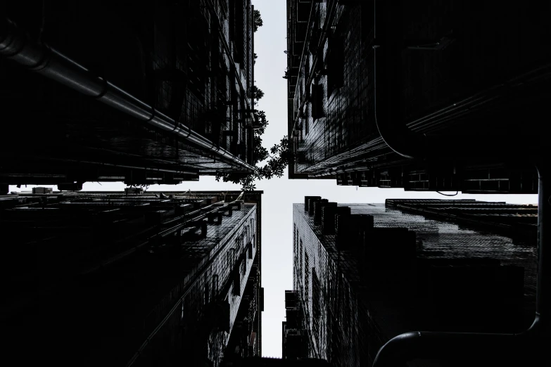 black and white pograph of an intersection between buildings