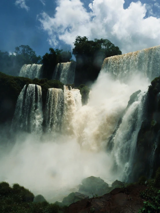 a view of some very pretty waterfalls with people