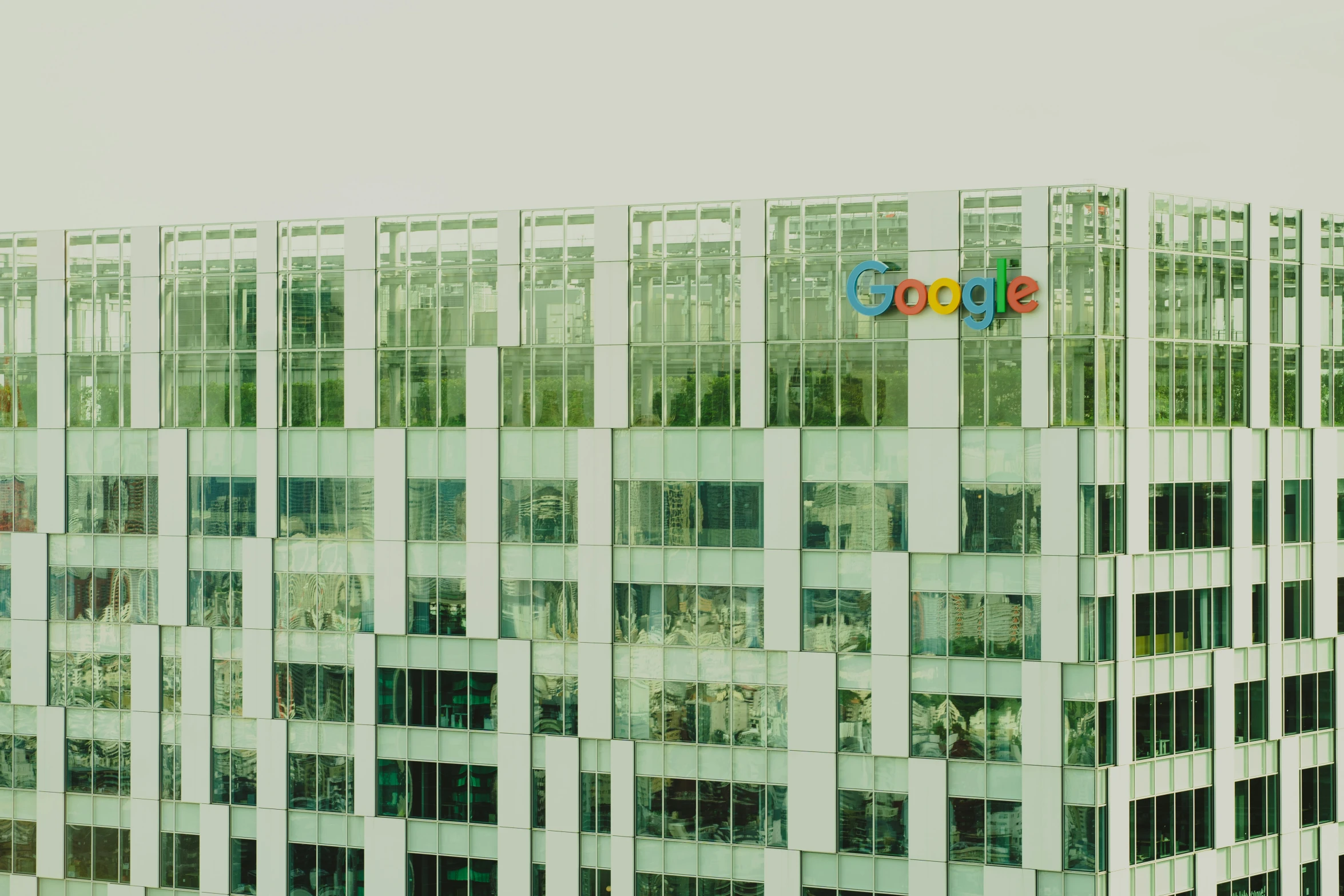 people are standing outside in front of a google building