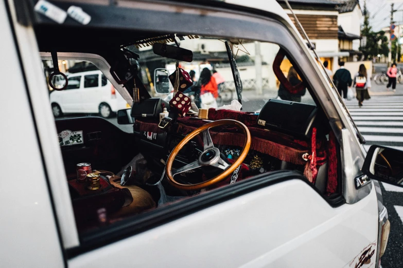 a white car with a wooden steering wheel