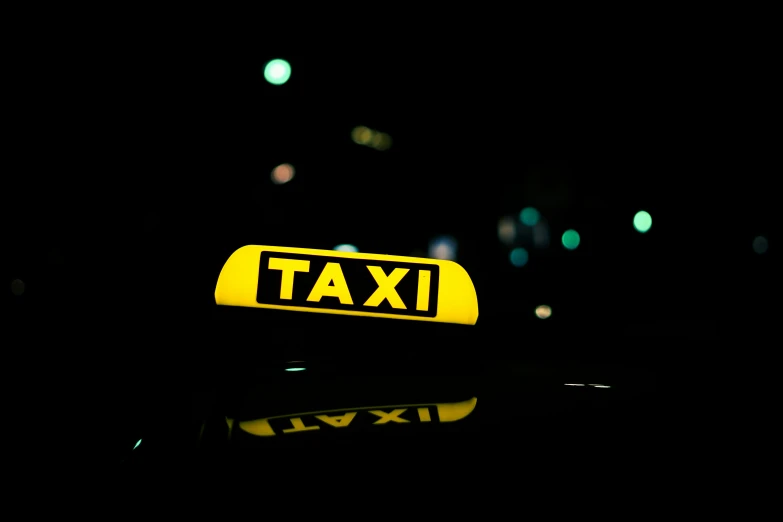 a taxi sign sitting on the dashboard of a car