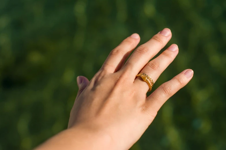 a woman with an open hand holding a ring