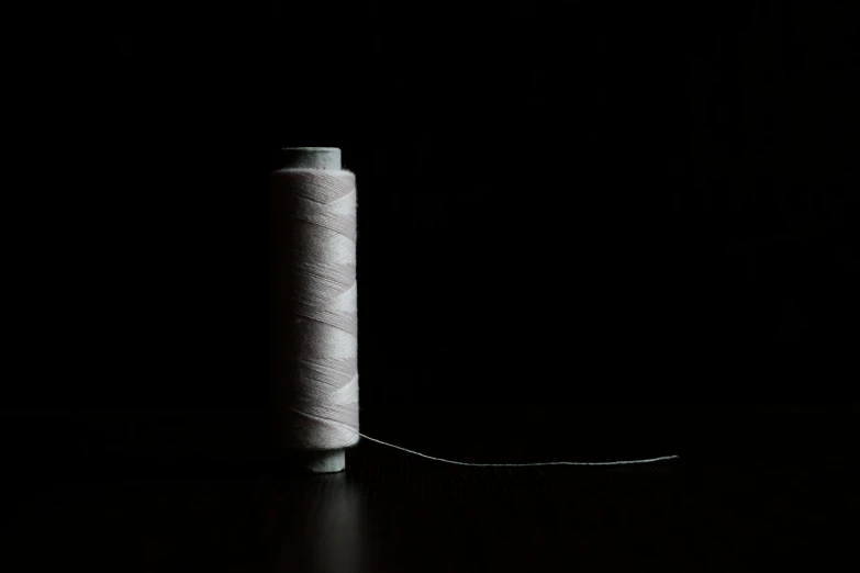 a spool of thread is shown in the dark