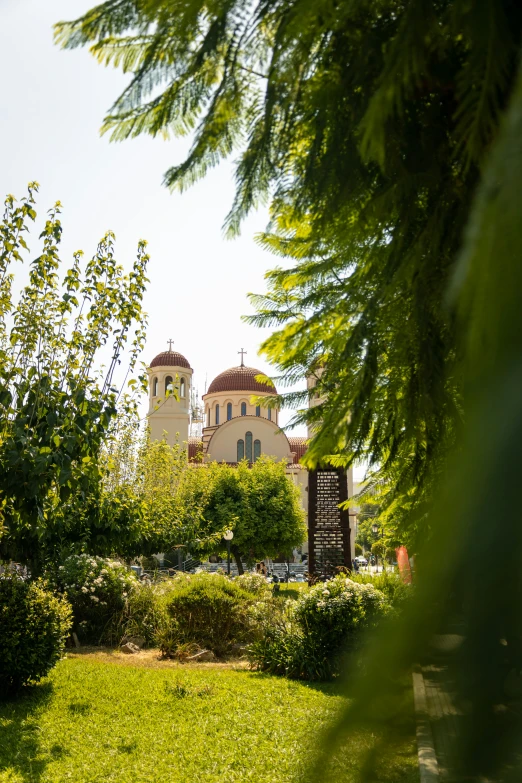 a view of the back of a building through some trees