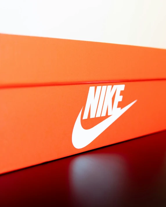 an orange box that has a white nike logo on it