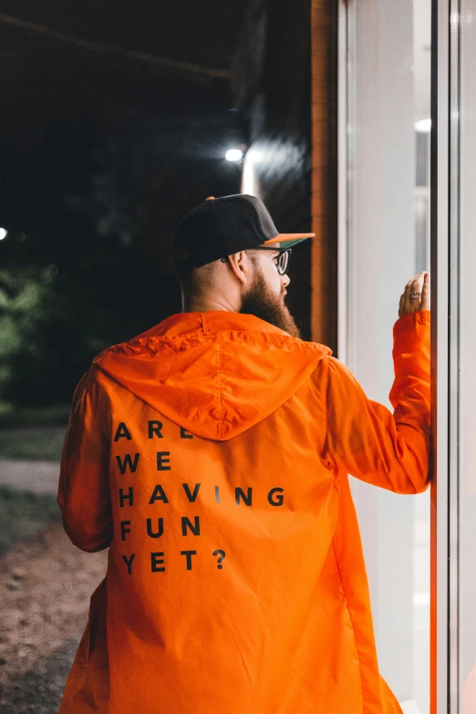 an image of man standing near window saying are we having fun yet?