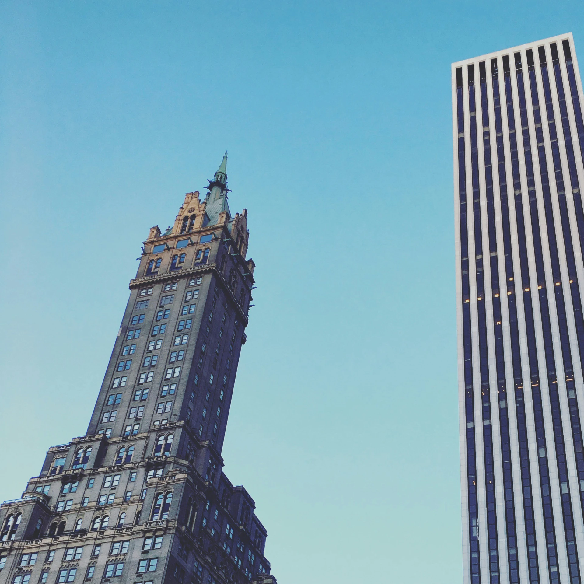 the sky is very clear next to two tall buildings