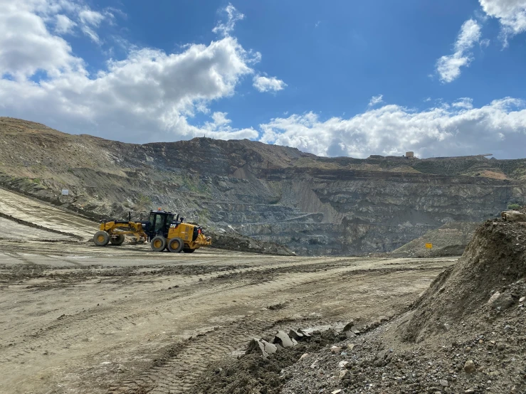 large trucks parked on top of a gravel field