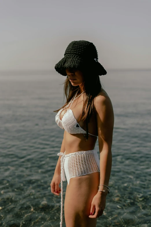 a woman in a bikini wearing a hat