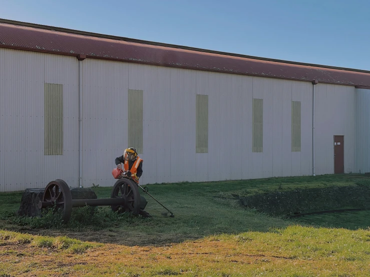 a tractor is parked outside by the wall