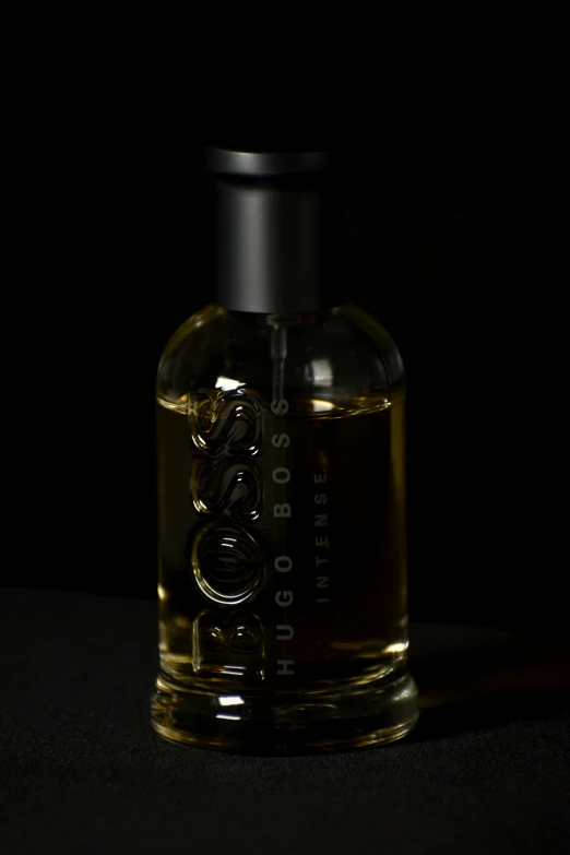 a bottle of cologne is pographed in the shadows