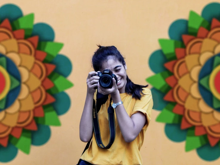 a woman is taking a picture with her camera