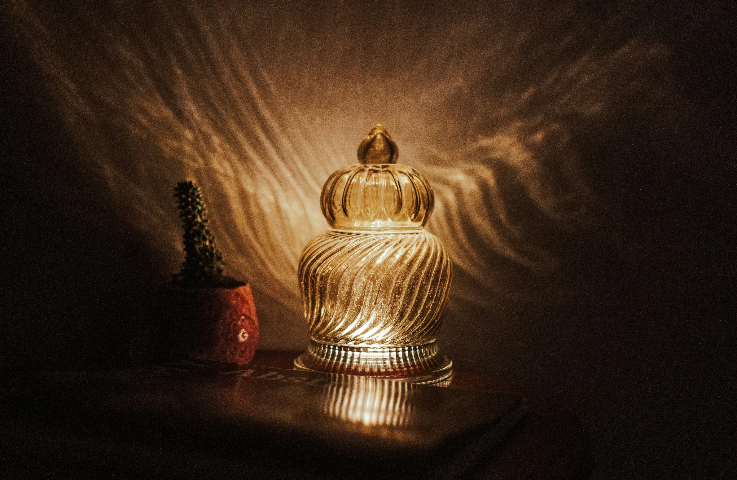 a bottle of wine next to an empty vase