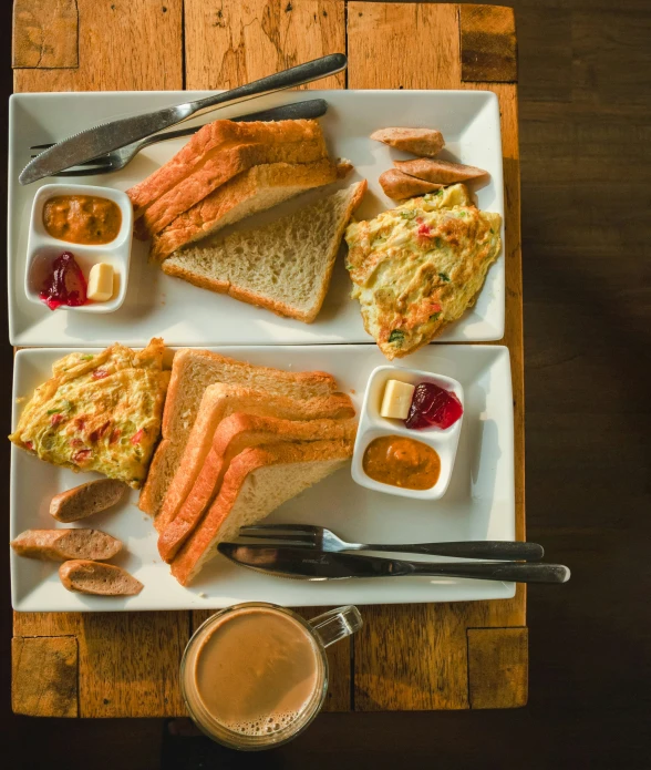 breakfast food sitting on a plate in front of a cup of coffee