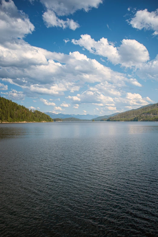 a lake filled with lots of blue water under clouds