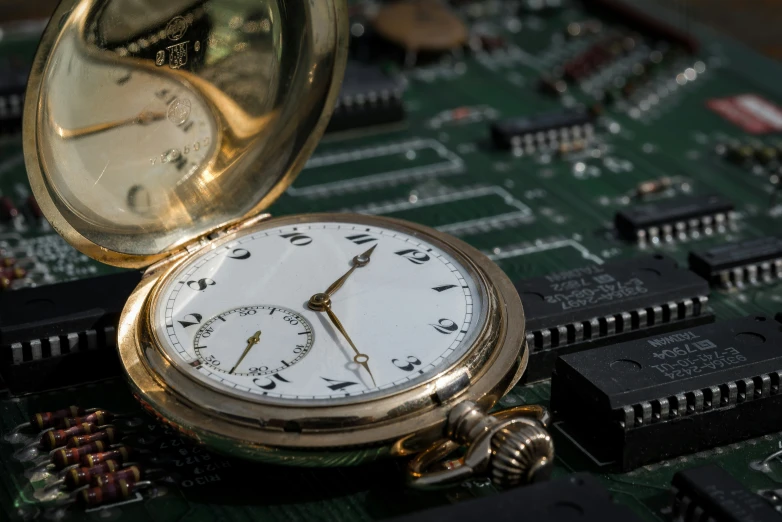 close up image of pocket watch on motherboard