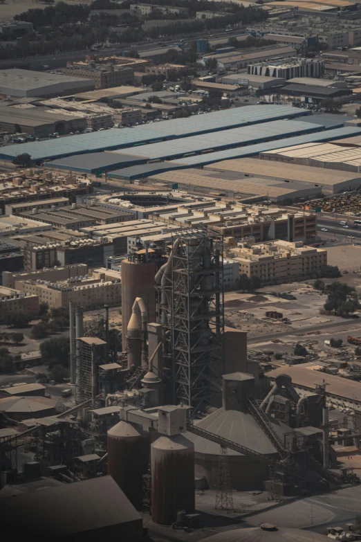 aerial view of industrial buildings and an airplane wing