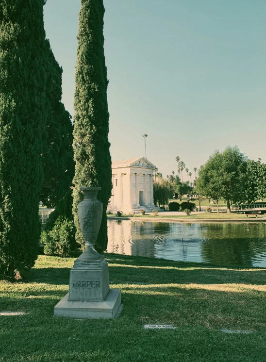 a white building and some trees in a park