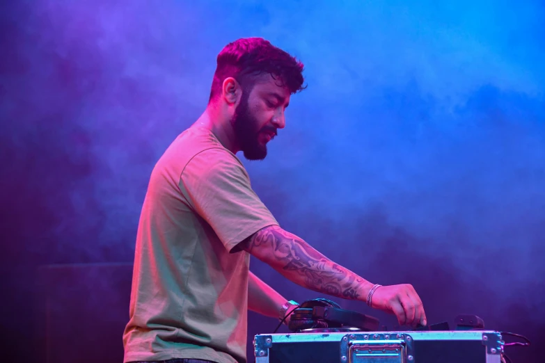 a man playing a music device at a concert