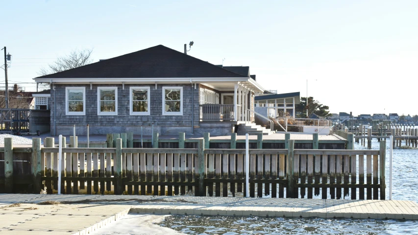 a house and water in front of a marina