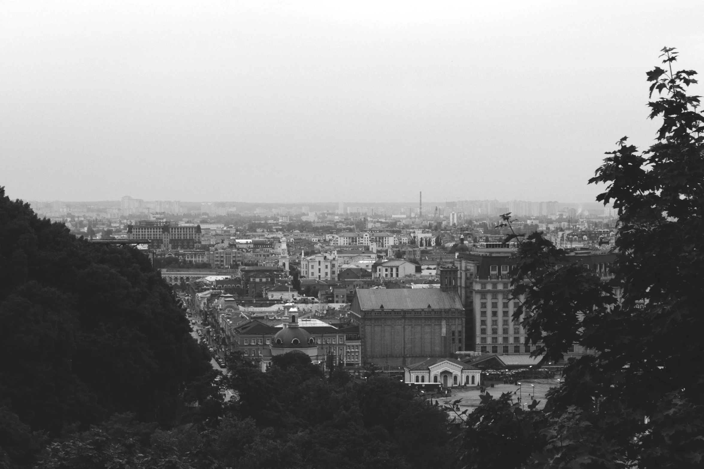 a view of a city with large buildings near trees