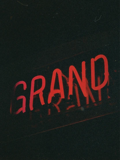 an old neon sign that reads, grand