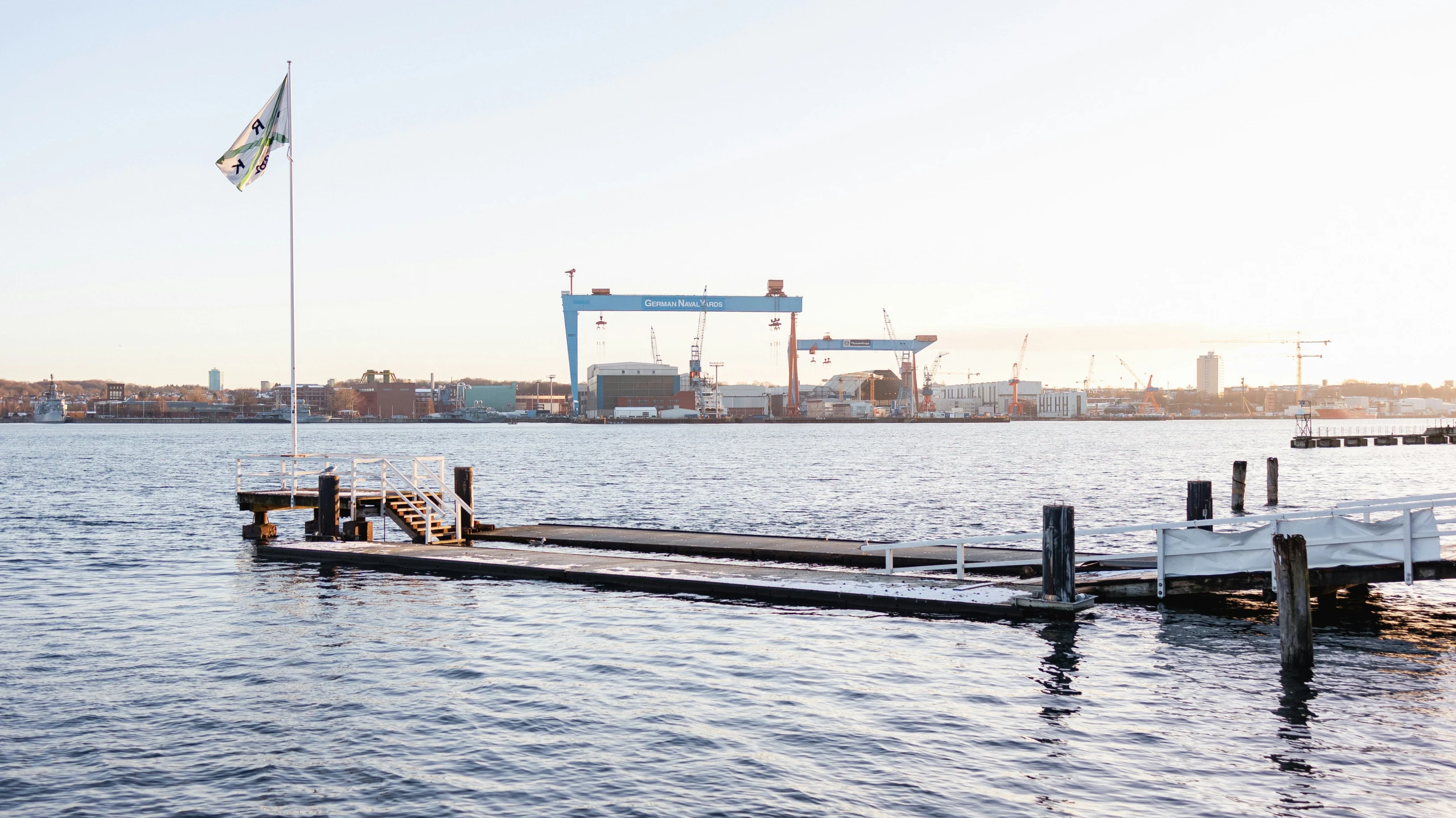 an open dock in front of large boats