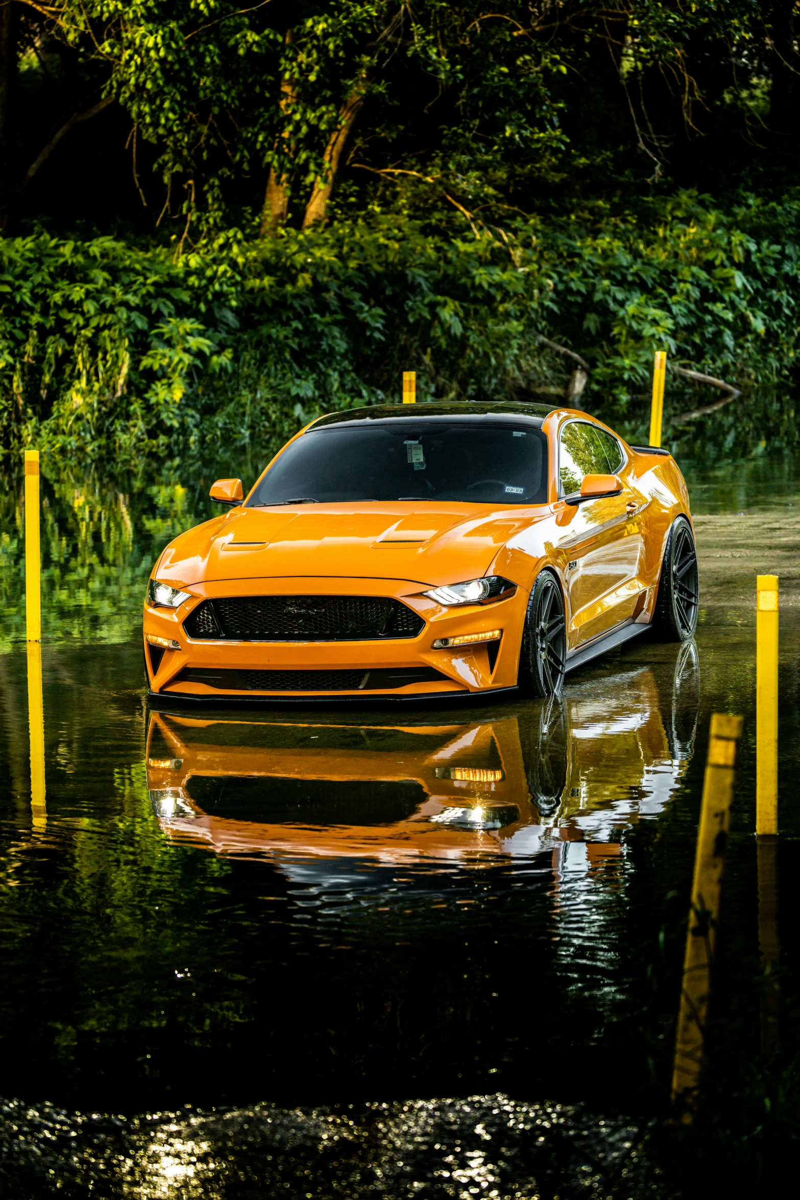 a sports car is parked in the wet street